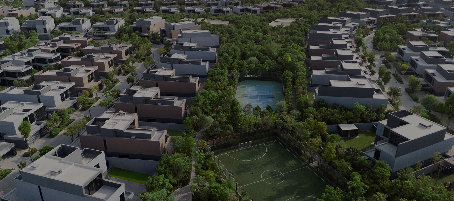 Aerial render of Masaar 3 villas and townhouses among dense trees, with sports courts