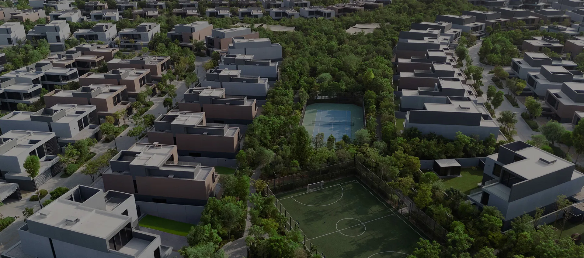 Aerial render of Masaar 3 villas and townhouses among dense trees, with sports courts